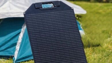 Maentum 50W faltbares Solarpanel steht aufgestellt vor türkisem Zelt auf grüner Wiese